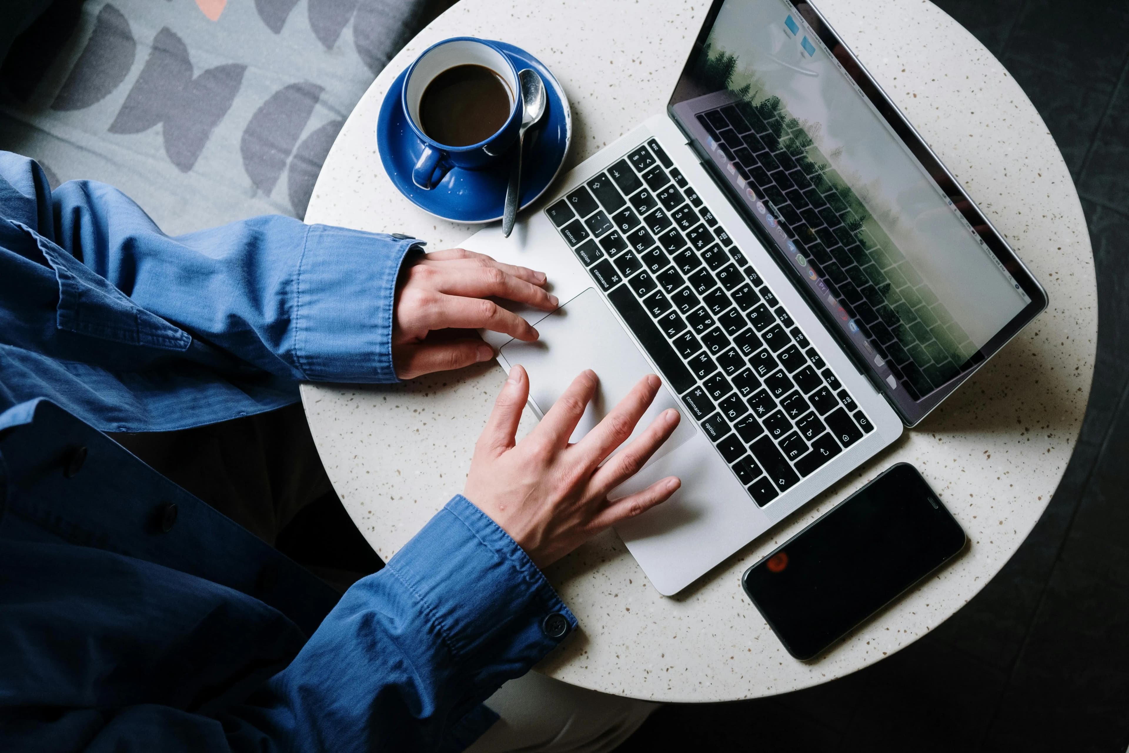 Professional working on a laptop in a modern workspace, highlighting the importance of reliable network infrastructure