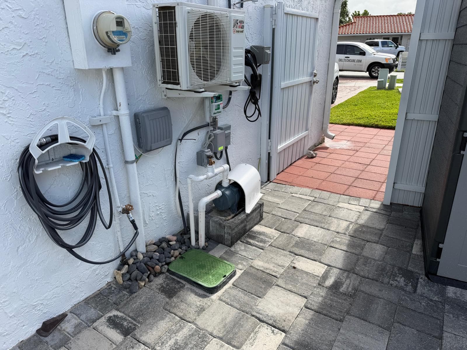 Sprinkler system pump and irrigation setup installed outside a Miami residential home