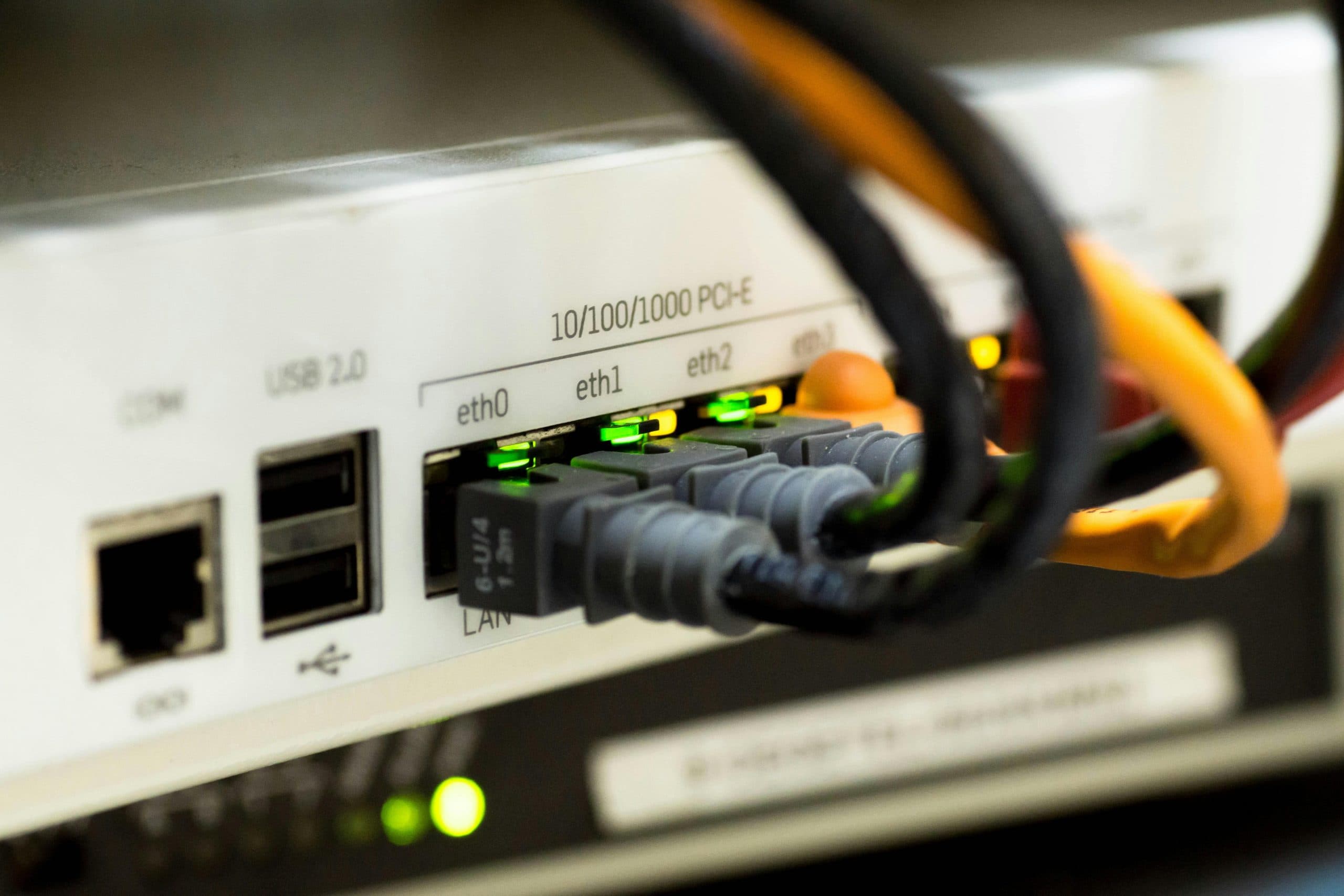 Close-up of Ethernet cables connected to a home router LAN ports for internet and network setup.