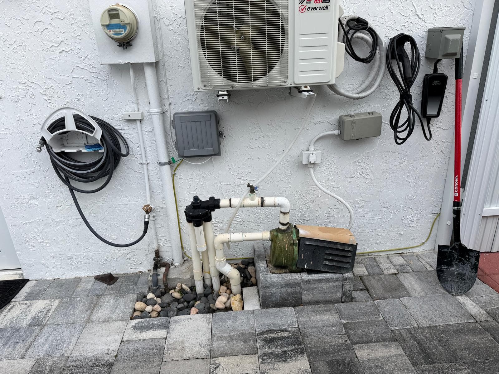 Old sprinkler pump system with worn motor, exposed PVC piping, and outdated irrigation setup before repair at a Miami residential property